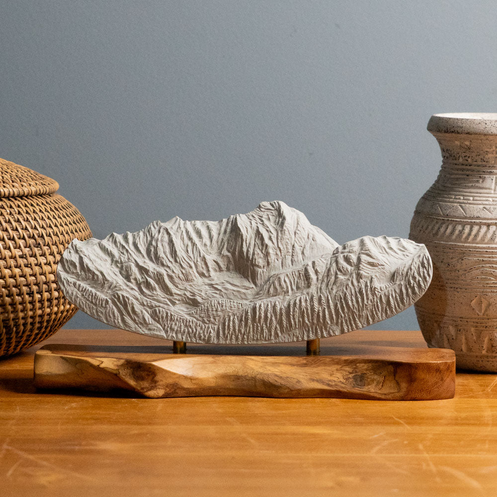 Hand carved stone sculpture of Capitol Peak on a table
